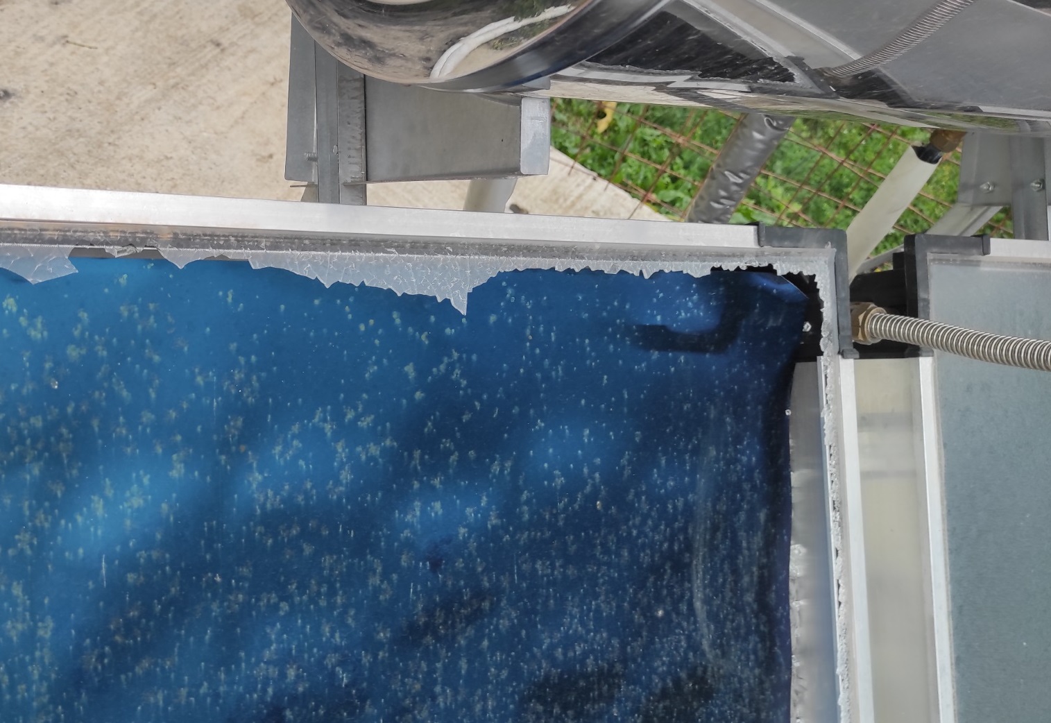 The solar glass has shattered and the interior of the collector is visible