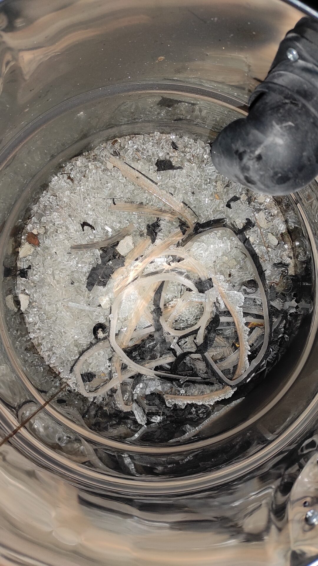 We collect the shards of the broken glass with a vacuum broom for safety reasons